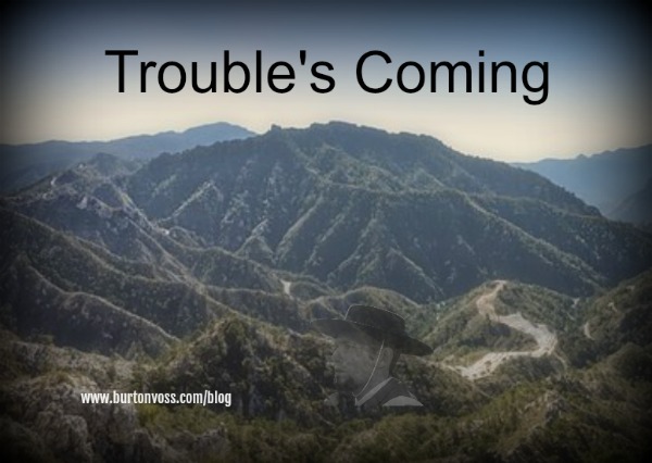 A faraway view of a dirt road snaking through the hills.