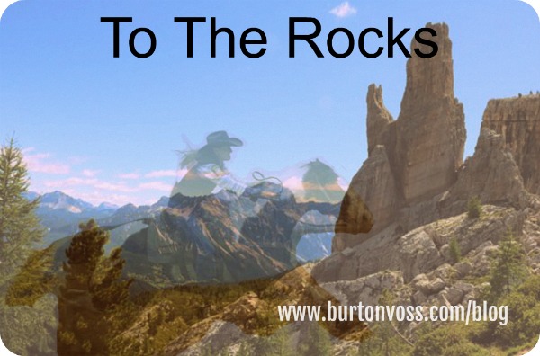 Ghost image of a female rider galloping to the rock formation.