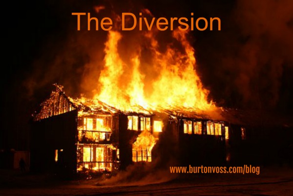 view of burning two-story wooden building fully  involved.